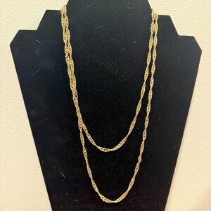 Vendome gold-colored necklace featuring a twisted, rope-like chain design